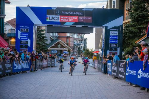 a group of people riding bikes down a street at Allegheny Spring 239 KING, bed/Ski-In, Out/Pool & Hot Tub in Snowshoe