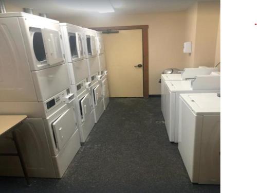 a large kitchen with white appliances in a room at Allegheny Spring 239 KING, bed/Ski-In, Out/Pool & Hot Tub in Snowshoe
