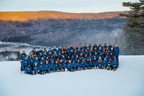 a group of people posing for a picture in the snow at Allegheny Spring 239 KING, bed/Ski-In, Out/Pool & Hot Tub in Snowshoe