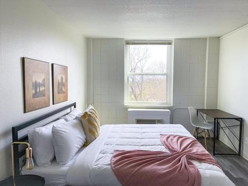 a bedroom with a large bed and a window at Sleepover Downtown Cincinnati 1BD 1BA Apartments in Cincinnati