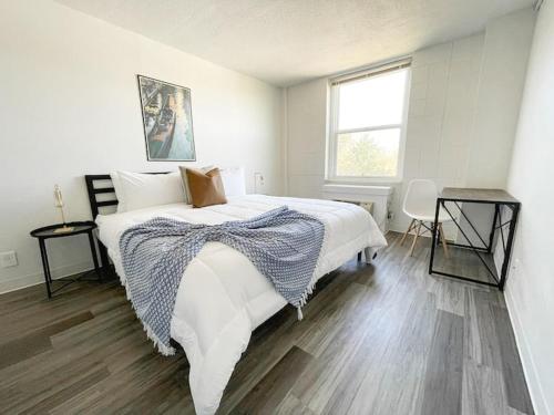a white bedroom with a bed and a window at Sleepover Downtown Cincinnati 1BD 1BA Apartments in Cincinnati