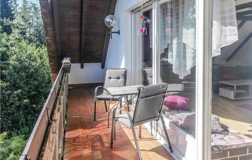 a patio with two chairs and a table on a balcony at Stunning Apartment In Marienmünster in Schieder-Schwalenberg