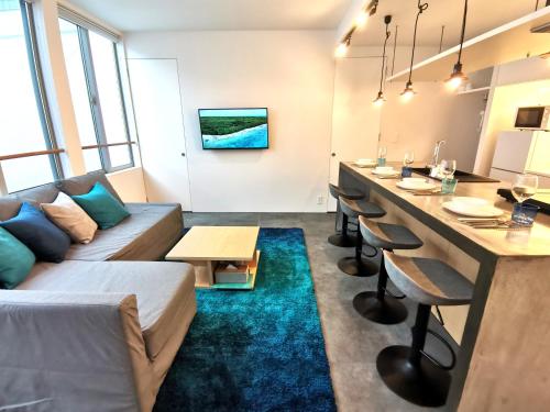 a living room with a bar and a couch at SHhotel 1フロア貸切り 広々2LDK in Naha