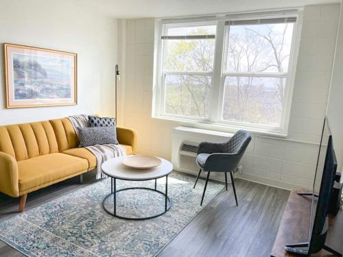 a living room with a couch and a table at Sleepover Downtown Cincinnati 1BD 1BA Apartments in Cincinnati