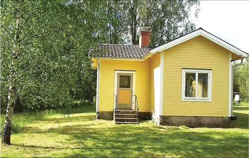 a small yellow house with a dog in a window at Nice Home In Ryd With Lake View in Ryd