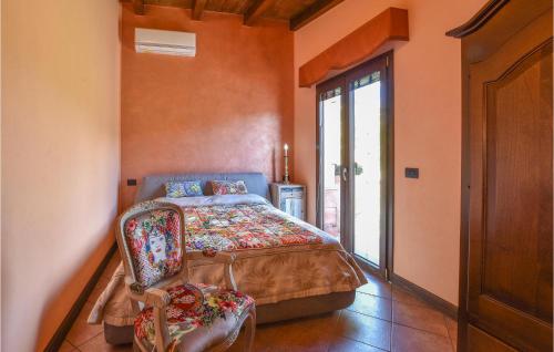 a bedroom with a bed and a chair in a room at 2 Bedroom Amazing Home In Troina in Troina