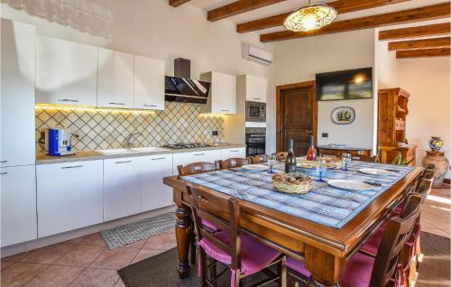 a kitchen with a table and chairs in a room at 2 Bedroom Amazing Home In Troina in Troina