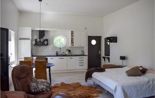 a kitchen with a bed and a table in a room at Cozy Apartment In Lagan With Wifi in Lagan