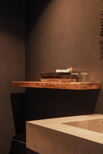 a wooden shelf with some items on top of it at Sui Boutique Hotel in Medellín
