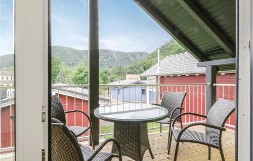 a patio with chairs and a table on a balcony at Ferienhausdorf Thale in Thale