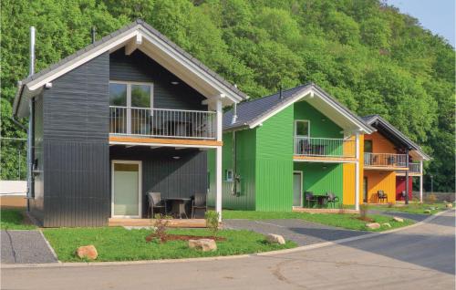a house that is painted green and yellow at Ferienhausdorf Thale in Thale