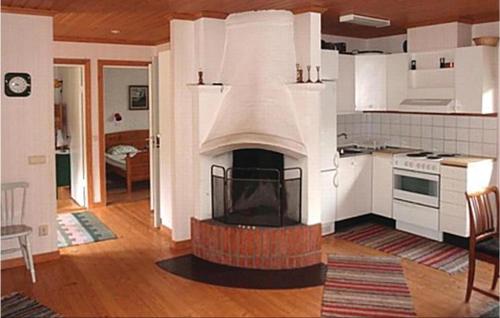a kitchen with a fireplace in the middle of a room at 2 Bedroom Gorgeous Home In Eksjö in Eksjö