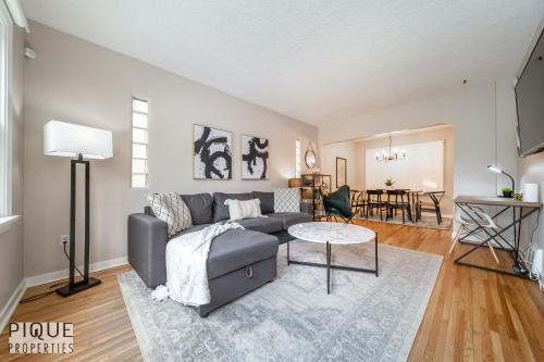 a living room with a couch and a table at 6 Bed Chic Stylish Home - 5 Mins to U of A & Whyte Ave - Fast Wi-Fi - Free Parking & Netflix in Edmonton