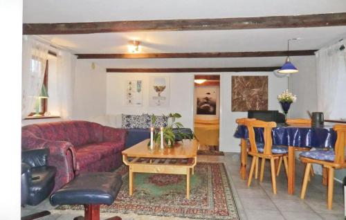 a living room with a red couch and a table at Röddehof in Blentarp