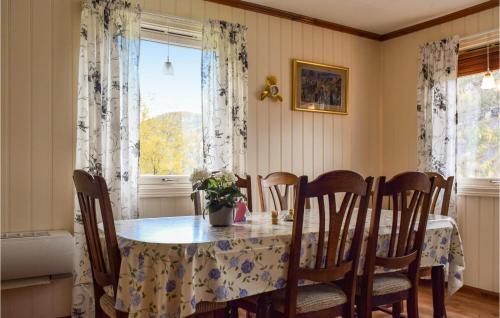 a dining room with a table and chairs and a window at Gorgeous Home In Bygland in Bygland