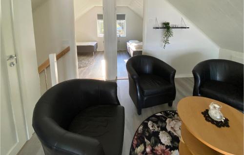 a living room with two chairs and a table at 4 Bedroom Gorgeous Home In Skillingaryd in Skillingaryd