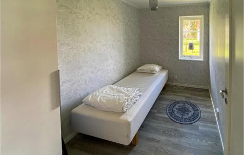 a small bedroom with a bed and a window at 4 Bedroom Gorgeous Home In Skillingaryd in Skillingaryd