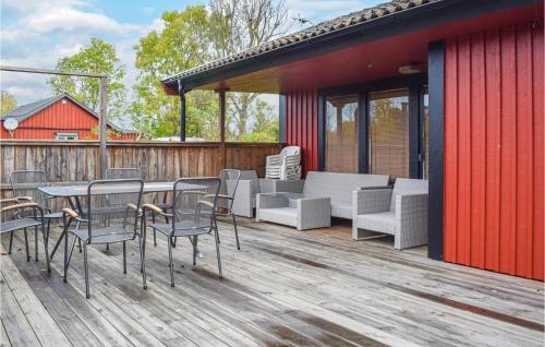 a deck with chairs and a table and chairs at Holiday Home Öjvägen Köpingsvik in Köpingsvik