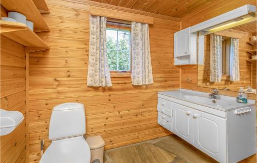 a bathroom with a toilet and a sink at Amazing Home In Sandane With 3 Bedrooms in Sandane