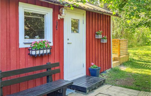 a red house with a white door and a bench at Awesome Home In Visby With 1 Bedrooms And Wifi in Visby