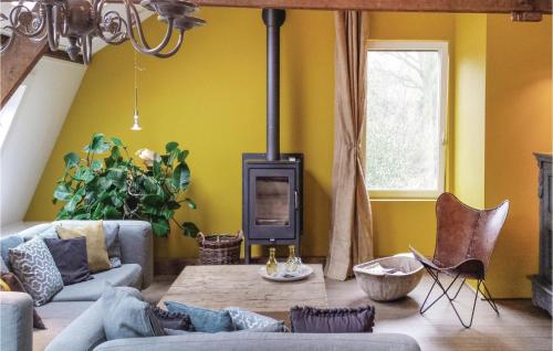 a living room with a couch and a wood stove at 3 Bedroom Pet Friendly Home In Leende in Leende