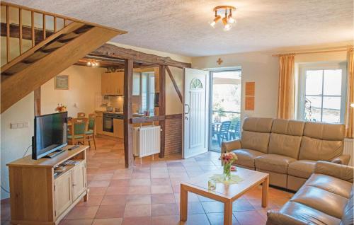 a living room with a couch and a tv at Haus Engel-Uriel in Steffeshausen