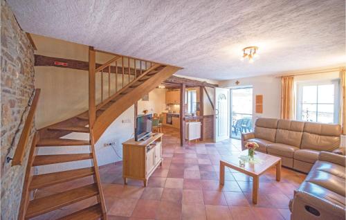 a living room with a spiral staircase in a house at Haus Engel-Uriel in Steffeshausen