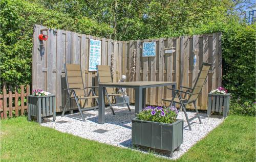 a patio with a table and chairs and a fence at Holiday Home Groote Keeten in Groote Keeten