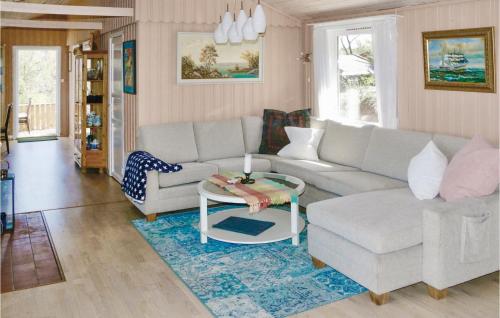 a living room with a couch and a table at Nice Home In Farsund With Wifi in Farsund