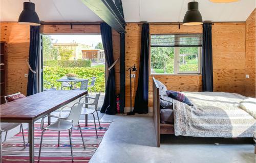 a bedroom with a bed and a table and chairs at Gorgeous Home In Loosdrecht With Kitchen in Loosdrecht