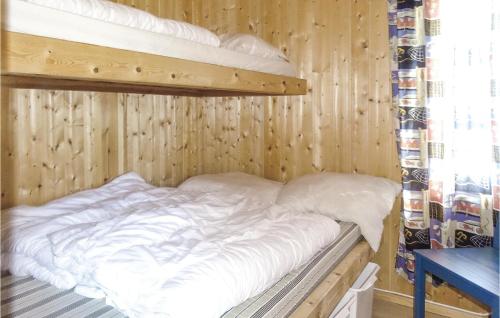 a bedroom with two bunk beds in a wooden wall at Nice Home In Dirdal With Ethernet Internet in Frafjord
