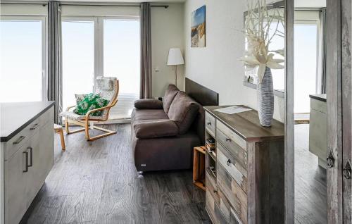 a living room with a couch and a chair at Beautiful Apartment In Graal-Müritz in Graal-Müritz