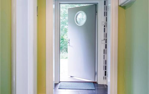 an open door with a clock on the wall at Holiday Home Hult Gunnarp Ätran in Bälshult