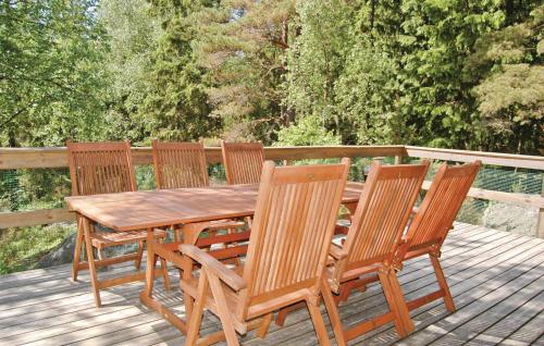 a wooden table and four chairs on a deck at Beautiful Home In Munkedal With Wifi in Munkedal