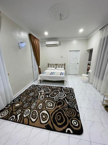 a bedroom with a bed and a rug on the floor at Cabin in the Woods by Abris in Bukit Gambir