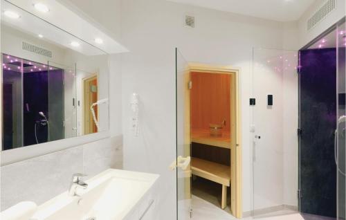 a bathroom with a sink and a shower and a mirror at Promenadenvilla in Priwall