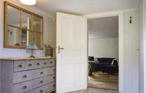 an open door leading into a living room with a dresser at Three-Bedroom Holiday Home In Vimmerby in Vimmerby