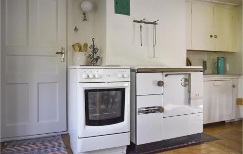 a kitchen with a white stove and an oven at Three-Bedroom Holiday Home In Vimmerby in Vimmerby
