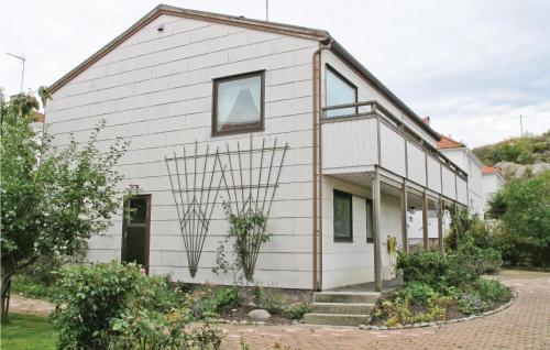 a house with white siding and a window at Nice Home In Lysekil With Sauna in Lysekil