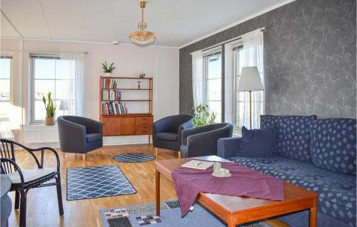 a living room with a blue couch and chairs at Beautiful Home In Säffle With Kitchen in Säffle