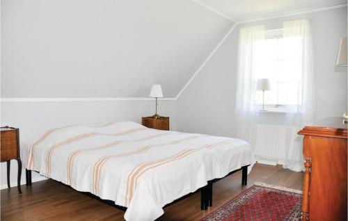 a white bedroom with a bed and a window at Beautiful Home In Säffle With Kitchen in Säffle