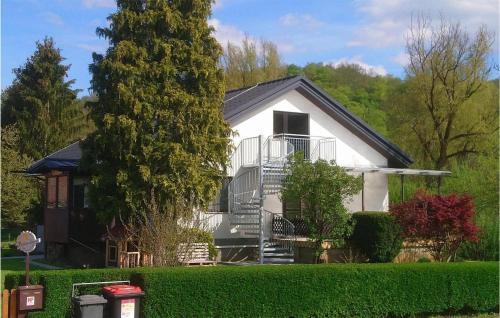 a white house with a tree and a yard at Ferienhaus In Hannersdorf in Hannersdorf