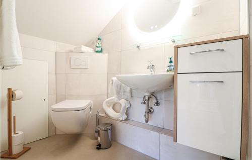 a white bathroom with a sink and a toilet at Ferienhaus In Hannersdorf in Hannersdorf