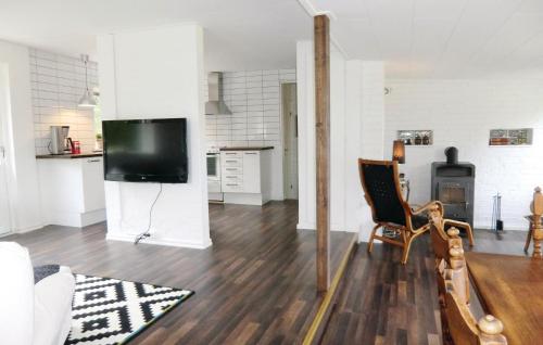 a living room with a flat screen tv on the wall at Nice Home In Örkelljunga With Kitchen in Fasalt