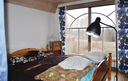 a bedroom with a bed and a lamp and a window at Awesome Apartment In Sunne With 1 Bedrooms And Wifi in Östra Ämtervik