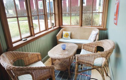 a room with chairs and a table and windows at Holiday Home Vätinge Mellangård Tranås in Gripenberg