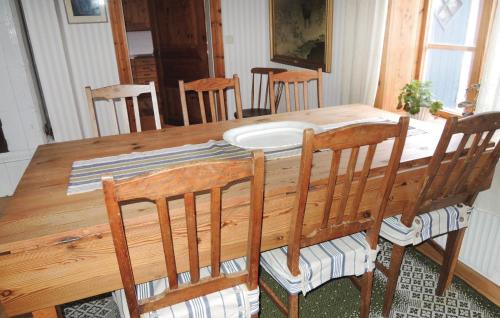 a dining room table with chairs and a wooden table and chairsktop at Holiday Home Vätinge Mellangård Tranås in Gripenberg