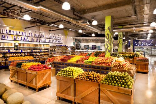 a grocery store filled with lots of fruits and vegetables at Sky-Rise Apartments in Los Angeles