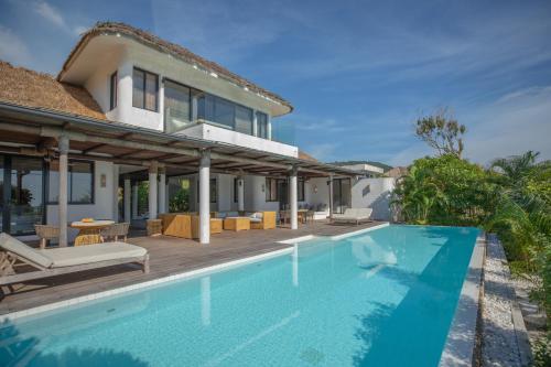 a swimming pool in front of a house at The Royal Sands Koh Rong in Koh Rong Island