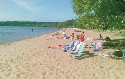 a group of people sitting on a beach at Gorgeous Home In Harlösa With Wifi in Harlösa